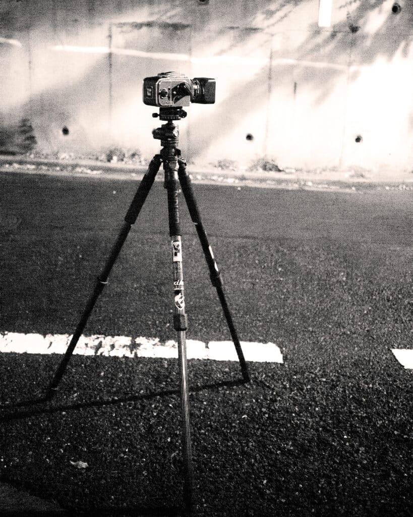 A Hasselblad camera on top of a tripod during a night photography session in Tokyo